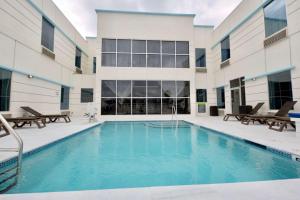 a swimming pool in the courtyard of a building with a building at voco St Augustine Historic Area, an IHG Hotel in St. Augustine