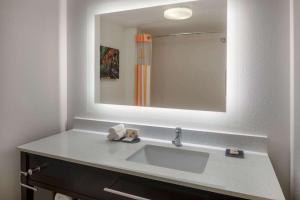 a bathroom with a sink and a large mirror at La Quinta by Wyndham Atlanta Douglasville in Douglasville