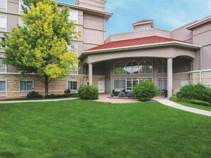 a large building with a green lawn in front of it at La Quinta by Wyndham Denver Airport DIA in Denver