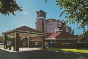 a large building with a tower on top of it at La Quinta by Wyndham Atlanta Alpharetta in Alpharetta