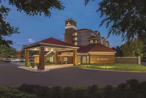 a rendering of a large building with a clock tower at La Quinta by Wyndham Atlanta Alpharetta in Alpharetta