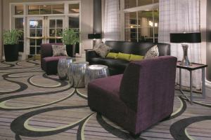 a lobby with a couch and chairs on a carpet at La Quinta by Wyndham Mesa Superstition Springs in Mesa