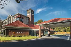 a building with a clock tower on top of it at La Quinta by Wyndham Atlanta Conyers in Conyers