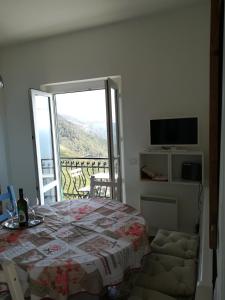 a bedroom with a bed and a balcony with a television at casa fiorella in San Bernardino