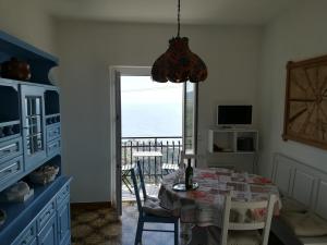 a dining room with a table and a view of the ocean at casa fiorella in San Bernardino