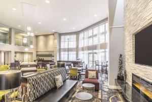 a lobby with couches and chairs and a fireplace at La Quinta by Wyndham Flagstaff in Flagstaff