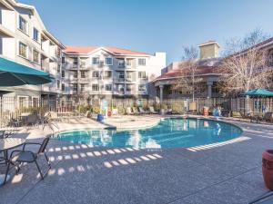 a swimming pool in front of a apartment complex at La Quinta by Wyndham Flagstaff in Flagstaff
