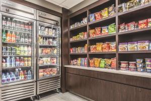 a grocery store aisle with shelves of food and drinks at La Quinta by Wyndham Orlando Lake Mary in Lake Mary