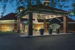 a building with potted plants in front of it at La Quinta by Wyndham Phoenix Chandler in Phoenix