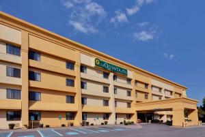 a hotel building with a sign on the front of it at La Quinta by Wyndham Plattsburgh in Plattsburgh