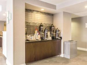 a kitchen with a counter with coffee makers on it at La Quinta by Wyndham Cleveland - Airport North in Cleveland