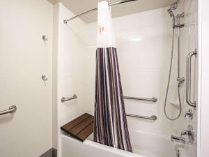 a bathroom with a shower and a tub at La Quinta by Wyndham Baltimore N / White Marsh in Baltimore +31 photos
