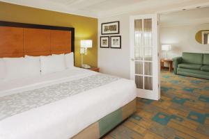 a hotel room with a large bed and a couch at La Quinta by Wyndham Salt Lake City Airport in Salt Lake City +36 photos