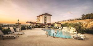 a hotel with a swimming pool in front of a building at La Quinta by Wyndham Marble Falls in Marble Falls