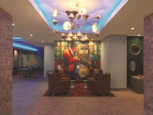 a lobby of a hotel with a painting on the wall at La Quinta by Wyndham New Orleans Downtown in New Orleans