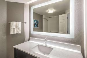 a bathroom with a sink and a mirror at La Quinta by Wyndham Orlando Lake Mary in Lake Mary