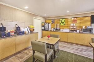 ペリーズバーグにあるLa Quinta Inn by Wyndham Toledo Perrysburgのテーブルと椅子が備わるファーストフードレストランです。