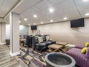 a waiting room with couches chairs and a tv at La Quinta by Wyndham Myrtle Beach - N. Kings Hwy in Myrtle Beach