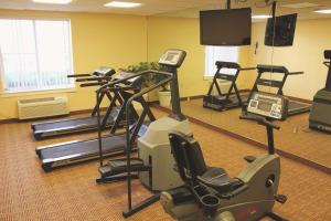 a gym with several exercise equipment in a room at La Quinta Inn & Suites by Wyndham Sawgrass in Sunrise