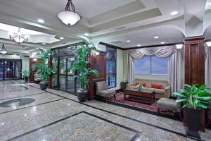 a lobby with potted plants in a building at La Quinta by Wyndham Downtown Conference Center in Little Rock