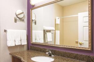 a bathroom with two sinks and a mirror at La Quinta by Wyndham Gainesville in Gainesville