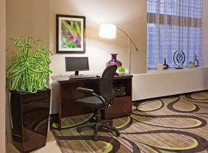 an office with a desk with a computer and a chair at La Quinta Inn by Wyndham Oshkosh in Oshkosh