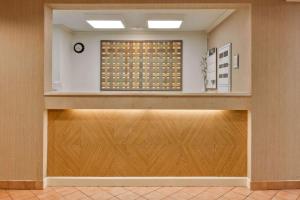 an empty lobby with a large window and wooden doors at La Quinta by Wyndham Lakeland East in Lakeland