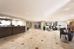 a lobby of a hotel with couches and a waiting room at La Quinta by Wyndham Miami Airport East in Miami