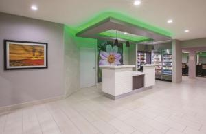 a store lobby with a flower on the wall at La Quinta by Wyndham NW Tucson Marana in Tucson