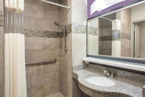 a bathroom with a sink and a mirror at La Quinta by Wyndham Fort Walton Beach in Fort Walton Beach