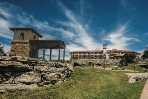 a stone wall in front of a building at La Quinta by Wyndham Marble Falls in Marble Falls