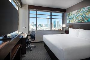 a hotel room with a bed and a desk and a window at Hyatt Place San Francisco/Downtown in San Francisco
