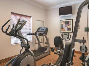 a gym with two exercise bikes and a treadmill at La Quinta by Wyndham Slidell - North Shore Area in Slidell