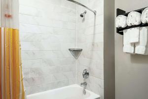 a bathroom with a shower with a tub and a sink at La Quinta Inn by Wyndham Livermore in Livermore