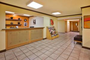 a lobby with a waiting room with a counter at La Quinta by Wyndham Savannah Southside in Savannah