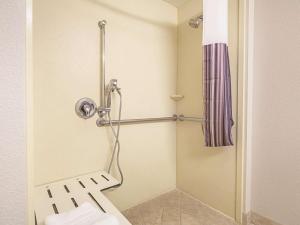 a bathroom with a toilet and a shower at La Quinta by Wyndham Fresno Northwest in Fresno