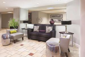 a lobby with a couch and chairs in a room at La Quinta by Wyndham Miami Airport East in Miami