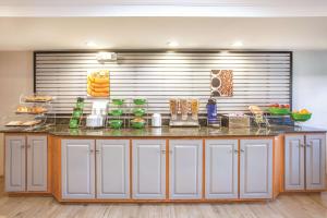 a kitchen with a counter with food on it at La Quinta Inn by Wyndham Richmond South in Chester