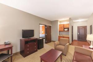 a large living room with a television and a couch at La Quinta by Wyndham Houston IAH Bush Intl Airport E in Humble