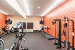 a gym with two treadmills and two tread machines at La Quinta by Wyndham Houston IAH Bush Intl Airport E in Humble