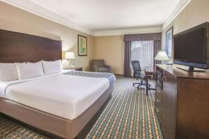 A bed or beds in a room at La Quinta by Wyndham Bay City