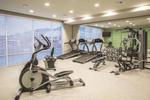 a gym with several treadmills and elliptical machines at La Quinta by Wyndham Hattiesburg - I-59 in Hattiesburg