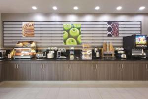 a fast food counter in a restaurant with food at La Quinta by Wyndham Corsicana in Corsicana