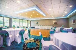 a banquet hall with tables and chairs in a room at La Quinta by Wyndham Baltimore South Glen Burnie in Glen Burnie