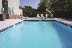a large blue swimming pool in a yard at La Quinta by Wyndham Rome in Rome