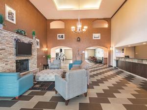 a lobby with chairs and a fireplace at La Quinta by Wyndham Glen Rose in Glen Rose