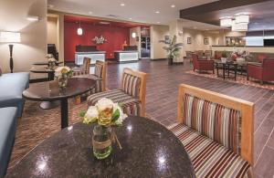 a lobby of a hotel with tables and chairs at La Quinta by Wyndham Wichita Falls - MSU Area in Wichita Falls