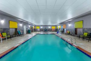 a large swimming pool with blue water in a room at La Quinta by Wyndham Horn Lake / Southaven Area in Horn Lake