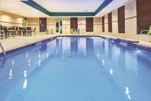 a large swimming pool with blue water at La Quinta by Wyndham Houston Willowbrook in Houston