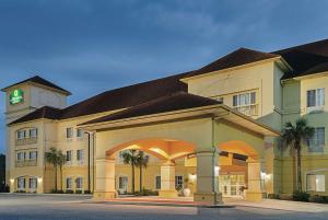 a large building with a clock tower on top of it at La Quinta by Wyndham Mobile Satsuma / Saraland in Satsuma